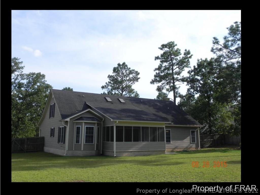596 East Lake Ridge Road Raeford, NC 28376 - Photo 3 of 25 a view of house with a big yard and potted plants in front of main door