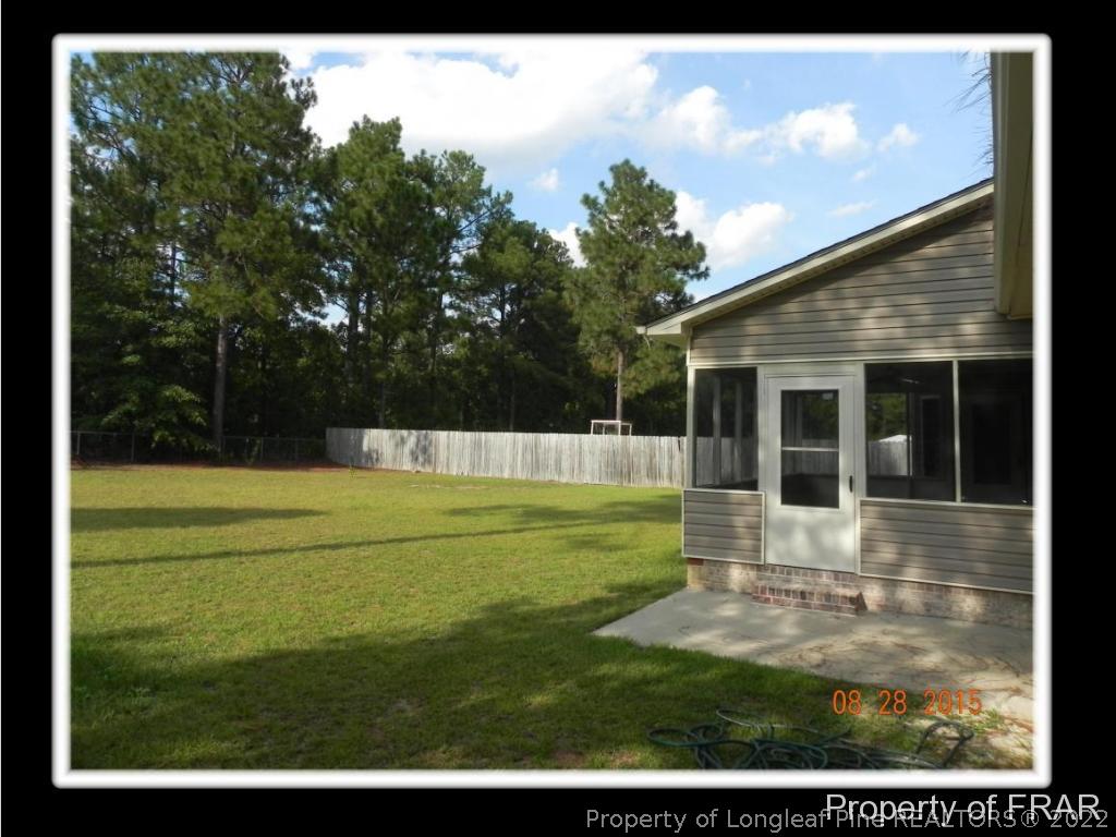 596 East Lake Ridge Road Raeford, NC 28376 - Photo 6 of 25 a view of a white house with a swimming pool
