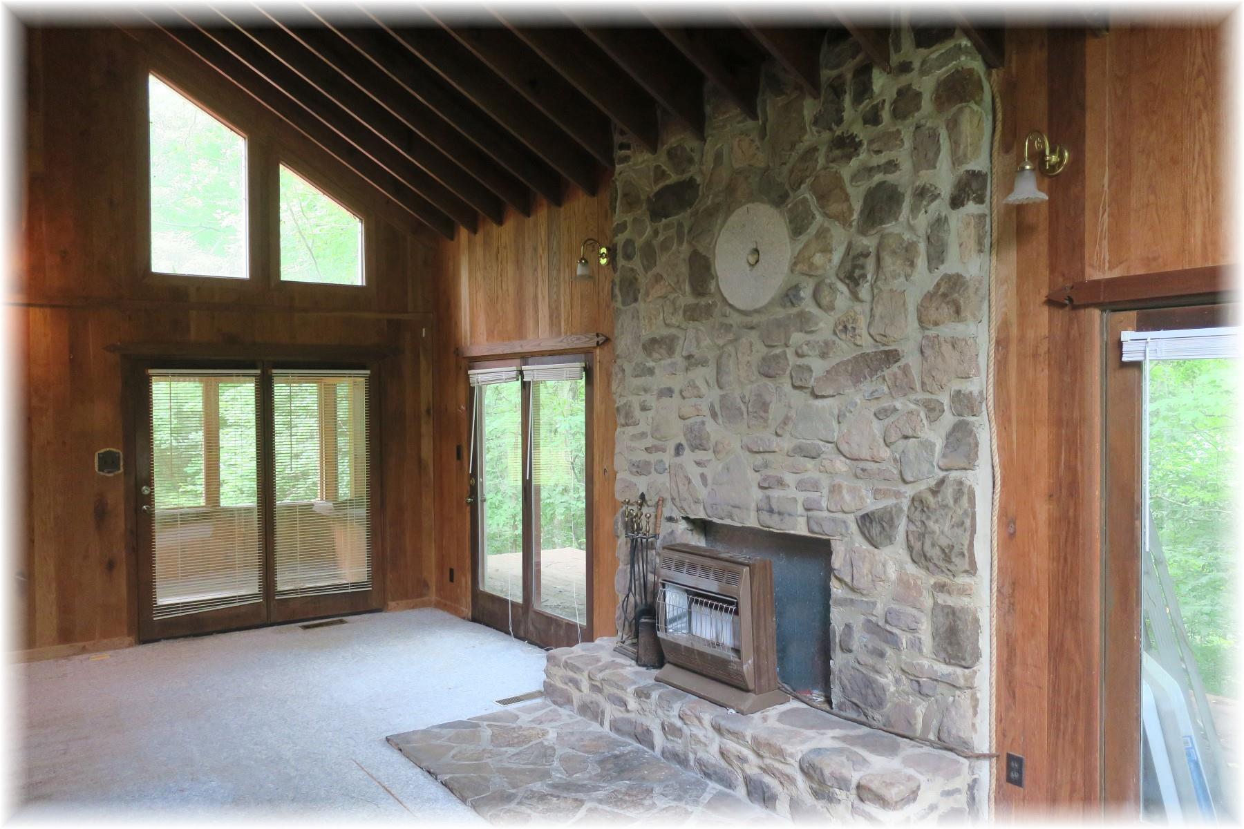 603 Thompson Road Pegram, TN 37143 - Photo 8 of 14 a view of an empty room with a fireplace and a window