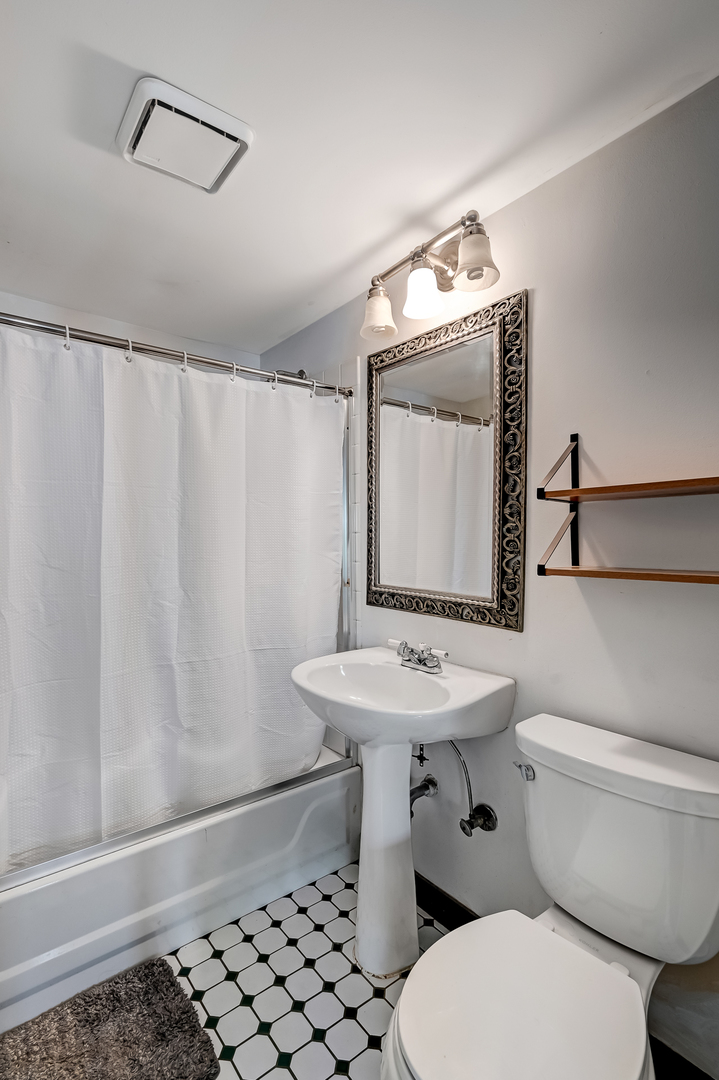 10511 South Hamlin Avenue Chicago, IL 60655 - Photo 12 of 23 a bathroom with a sink a toilet and mirror