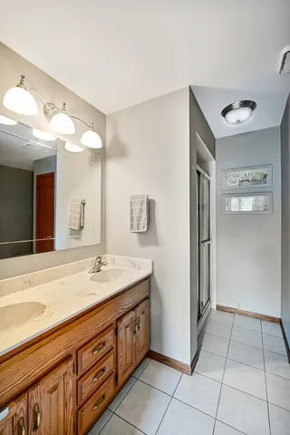a spacious bathroom with a sink a mirror and a shower