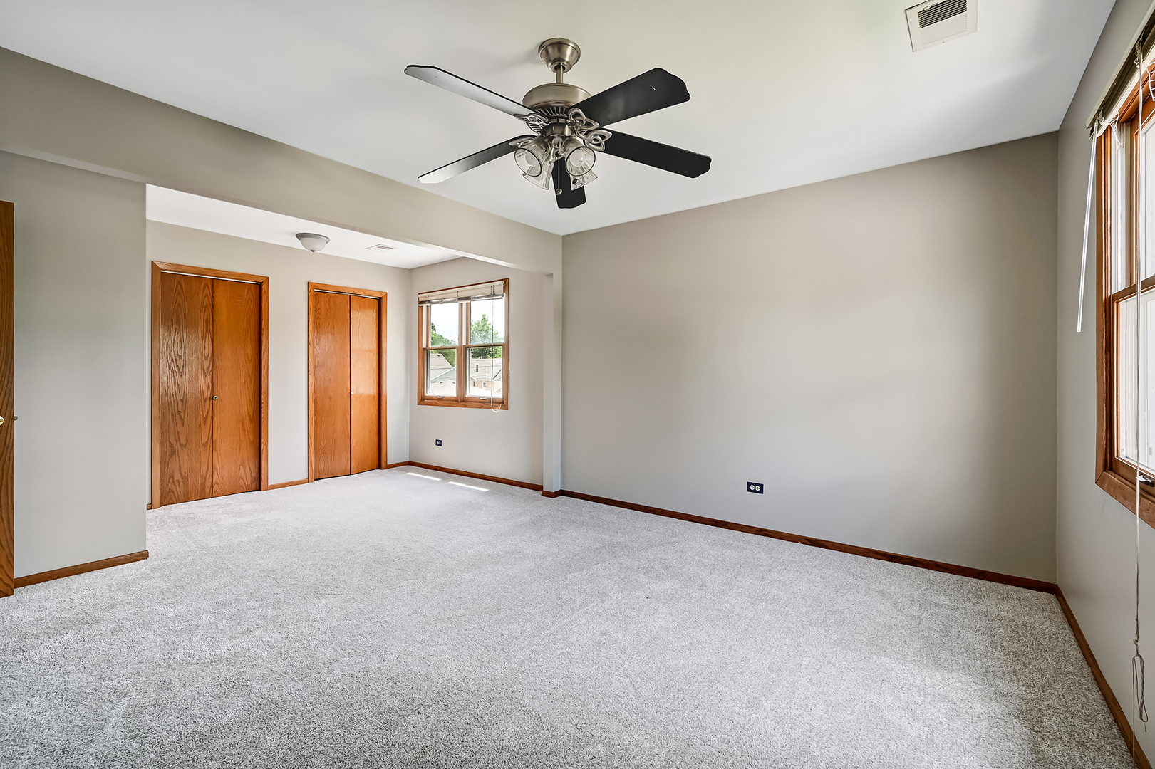 10511 South Hamlin Avenue Chicago, IL 60655 - Photo 18 of 23 an empty room with windows and ceiling fan