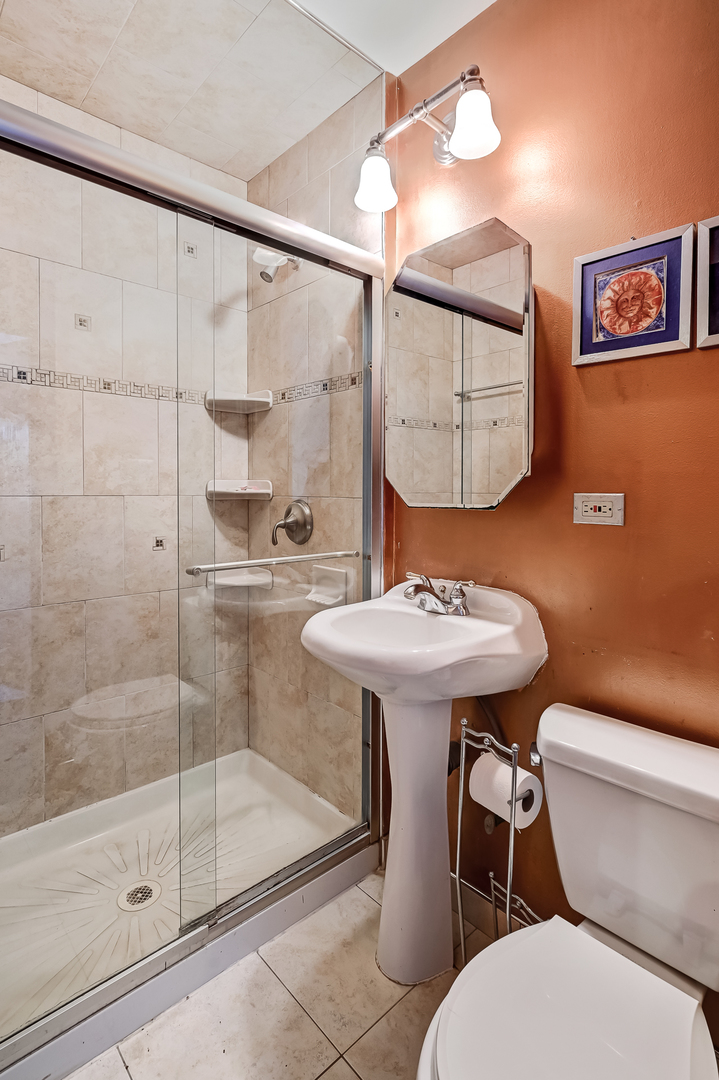 10511 South Hamlin Avenue Chicago, IL 60655 - Photo 19 of 23 a bathroom with a sink mirror toilet and shower