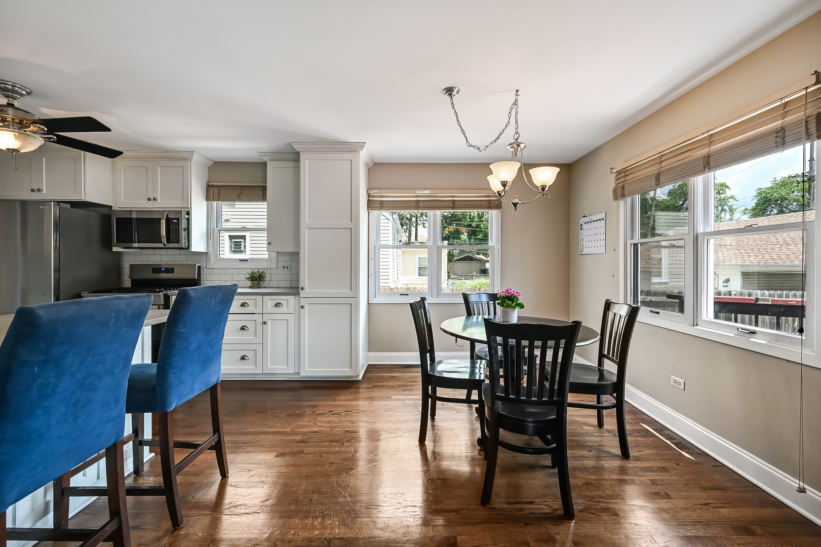 10511 South Hamlin Avenue Chicago, IL 60655 - Photo 8 of 23 a dining room with furniture a chandelier and wooden floor