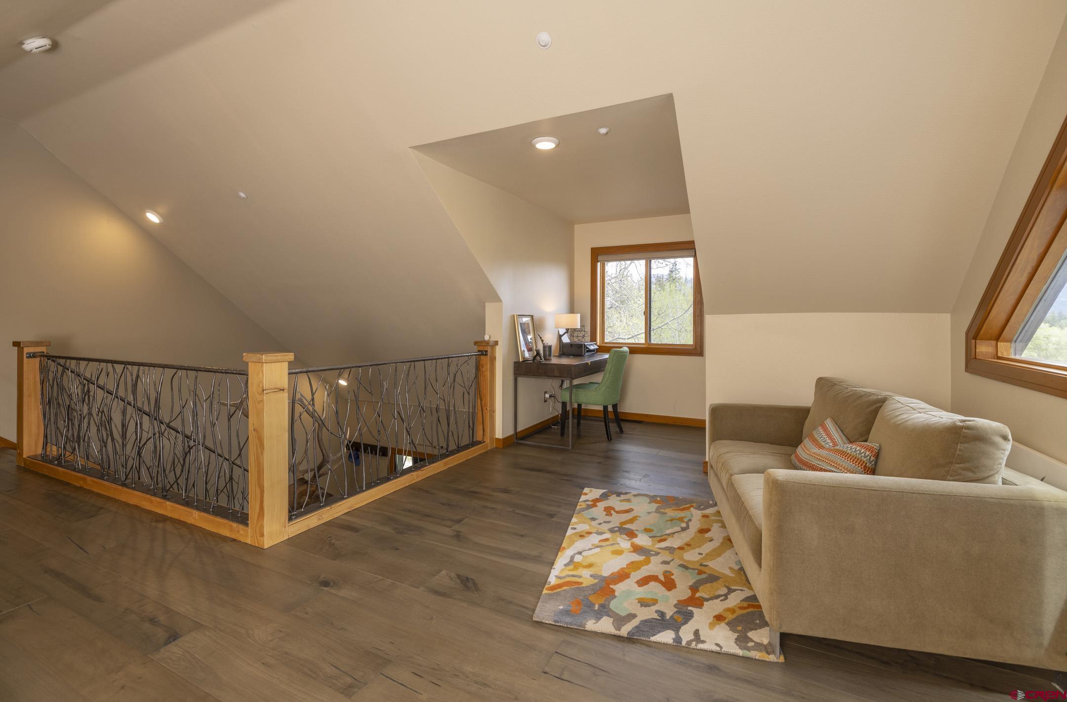 154 Falcon Ridge Road Durango, CO 81301 - Photo 27 of 42 a living room with furniture and a rug