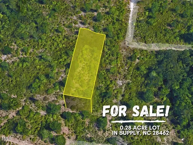 a view of a sign board with large trees