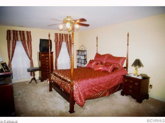 13241 Carters Way Road Chesterfield, VA 23838 - Photo 7 of 11 a spacious bedroom with a bed and a chandelier