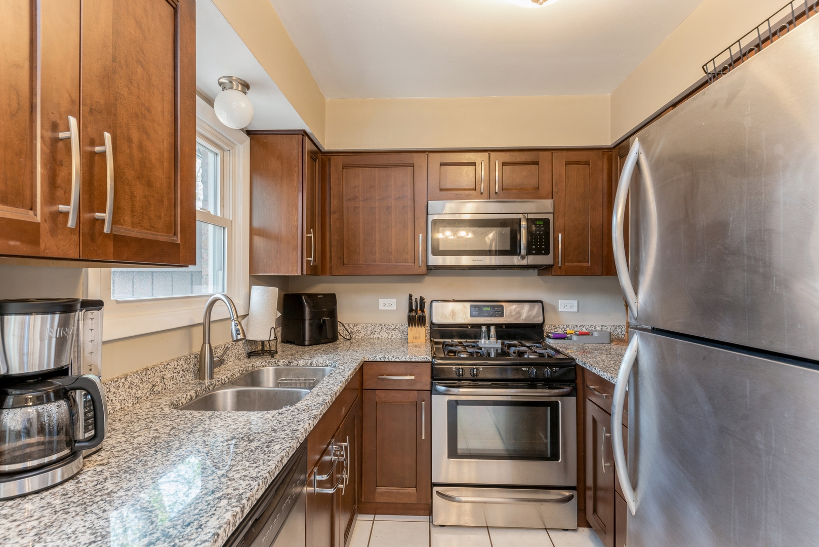 151 East Palatine Road, Unit 4 Palatine, IL 60067 - Photo 7 of 17 a kitchen with granite countertop a sink stove and microwave