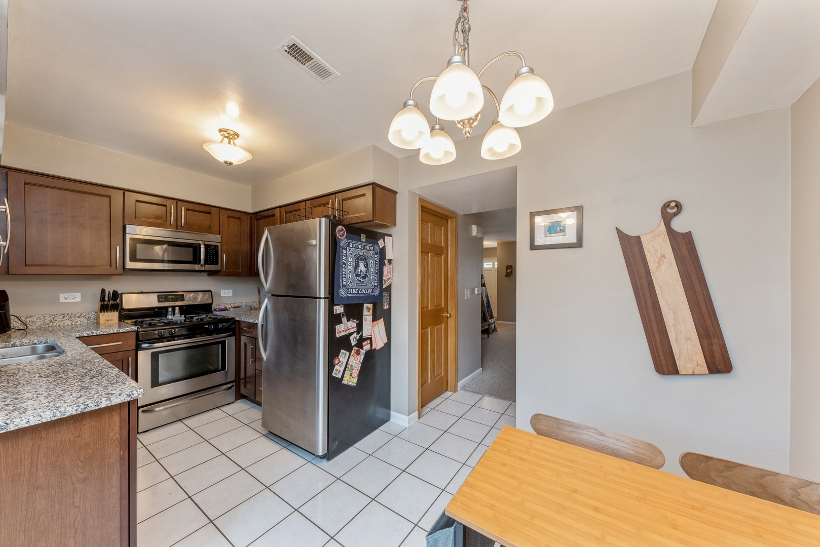 151 East Palatine Road, Unit 4 Palatine, IL 60067 - Photo 8 of 17 a kitchen with stainless steel appliances granite countertop a refrigerator a stove a sink dishwasher and a refrigerator with wooden floor