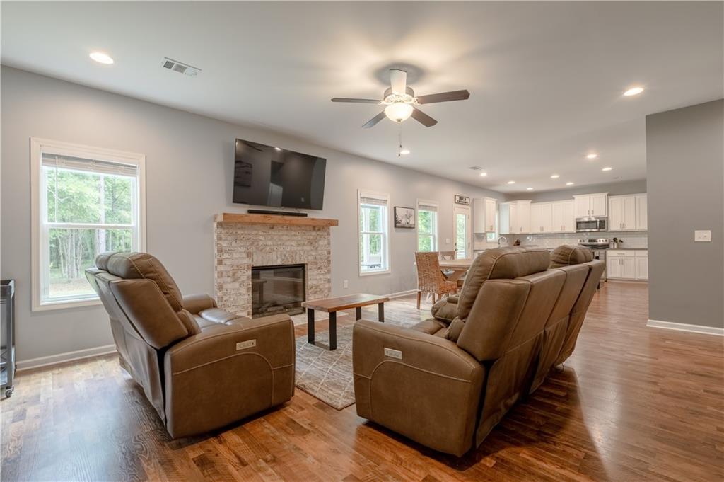 719 Fairview Road Brooks, GA 30205 - Photo 11 of 35 a living room with furniture a flat screen tv and a fireplace
