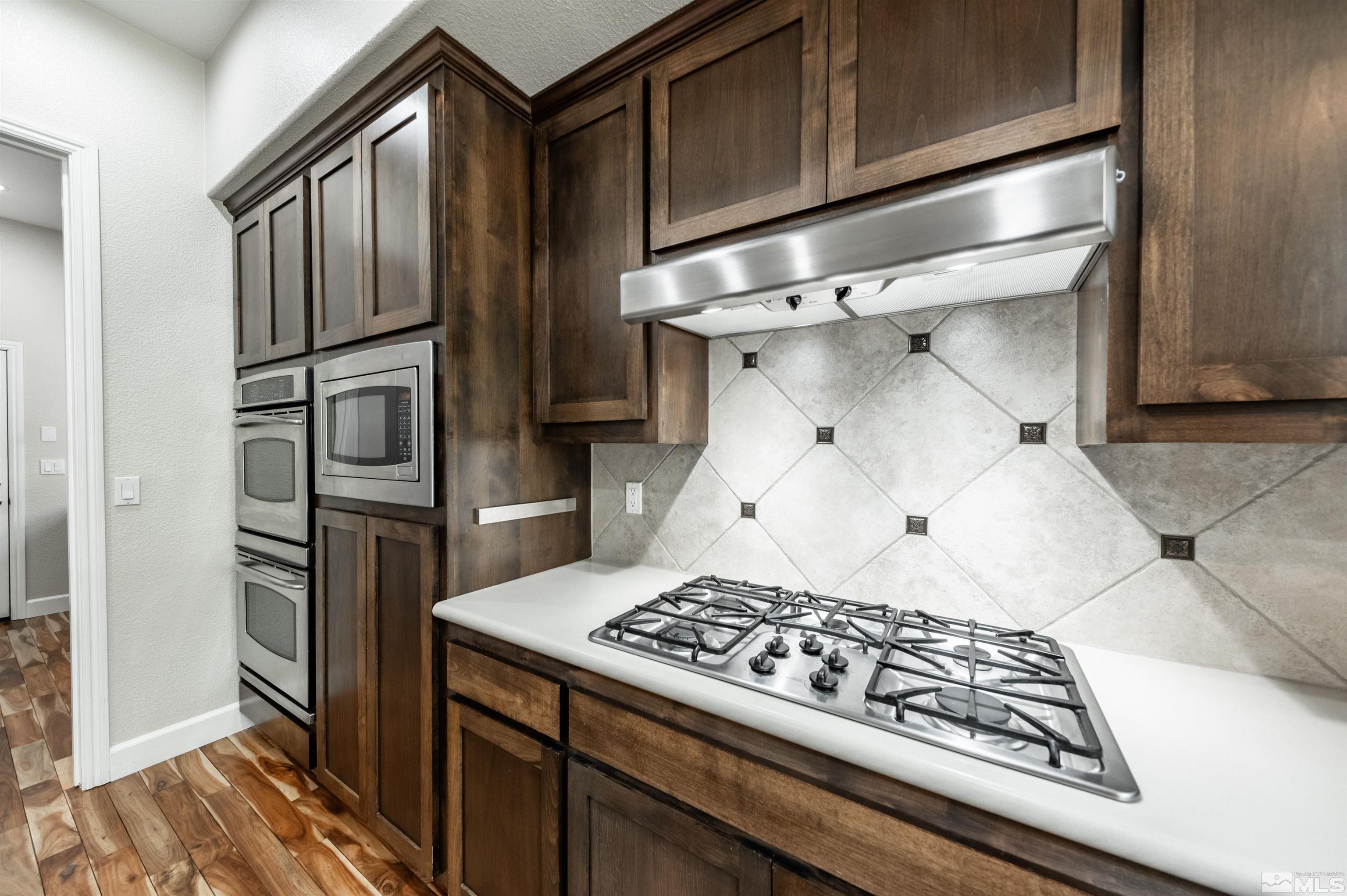 8580 Timaru Trail Reno, NV 89523 - Photo 19 of 40 a kitchen with a stove and a refrigerator