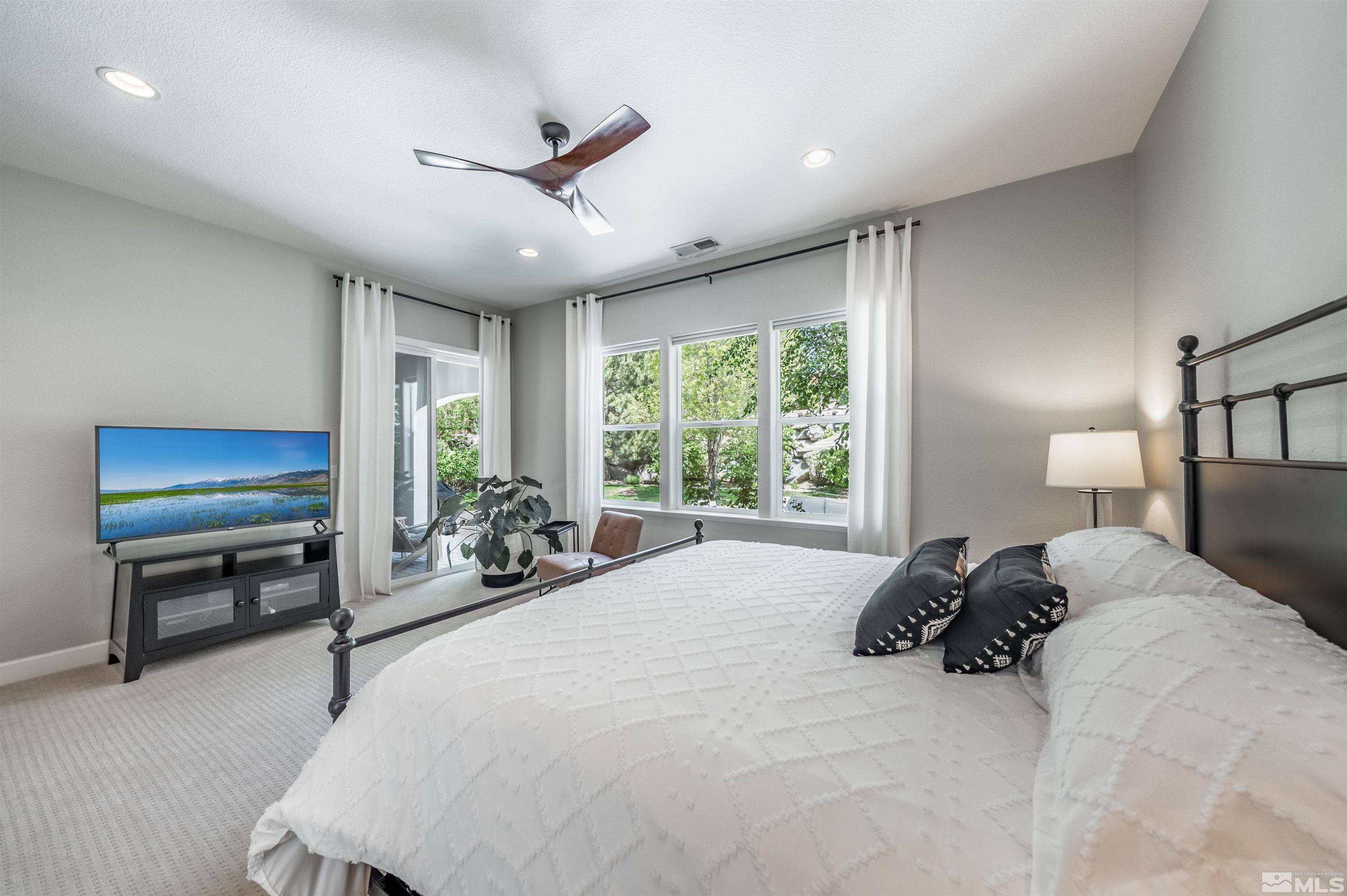 8580 Timaru Trail Reno, NV 89523 - Photo 23 of 40 a bed room with a bed and a large window