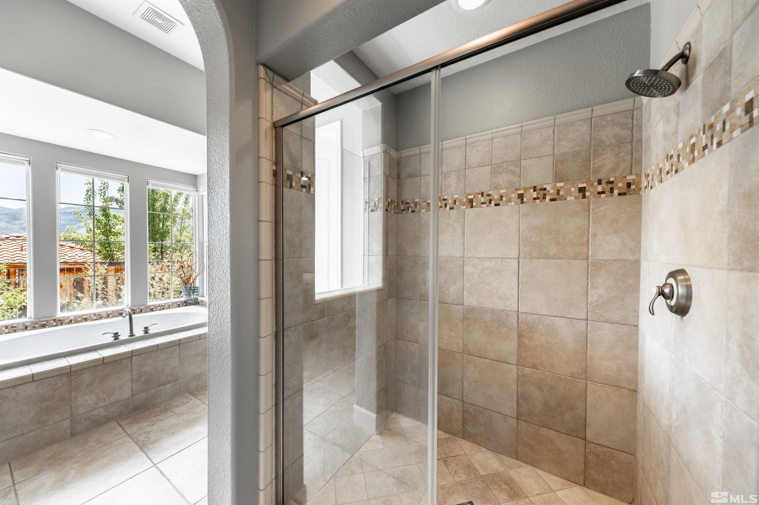 8580 Timaru Trail Reno, NV 89523 - Photo 26 of 40 a bathroom with a glass shower door