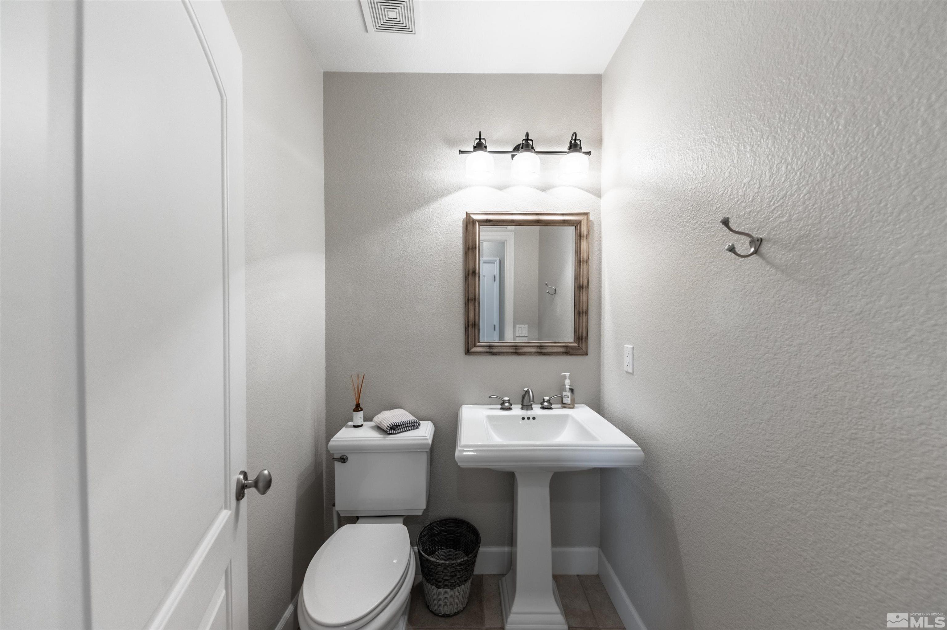 8580 Timaru Trail Reno, NV 89523 - Photo 28 of 40 a bathroom with a sink toilet and mirror