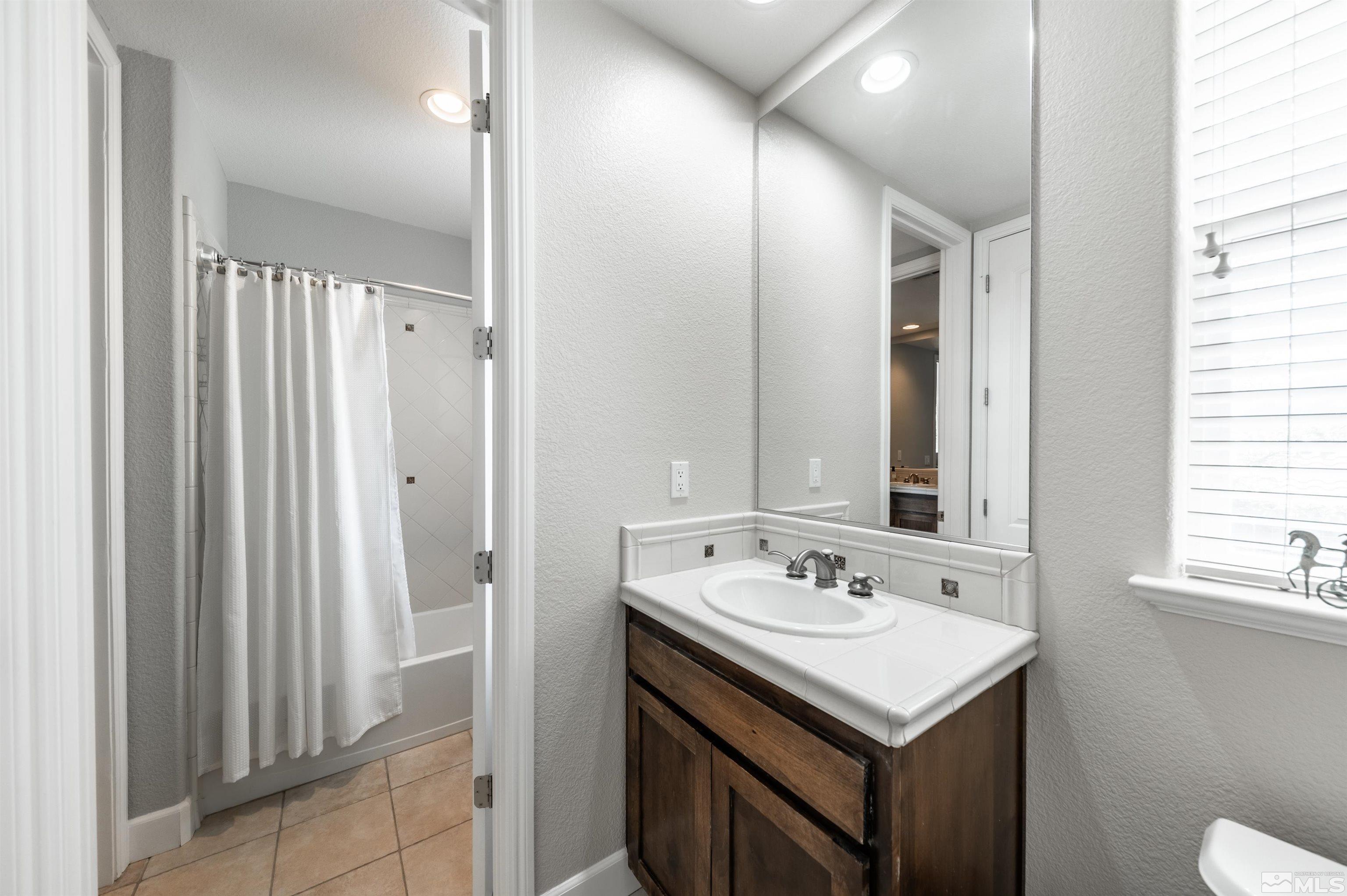 8580 Timaru Trail Reno, NV 89523 - Photo 30 of 40 a bathroom with a sink and a mirror