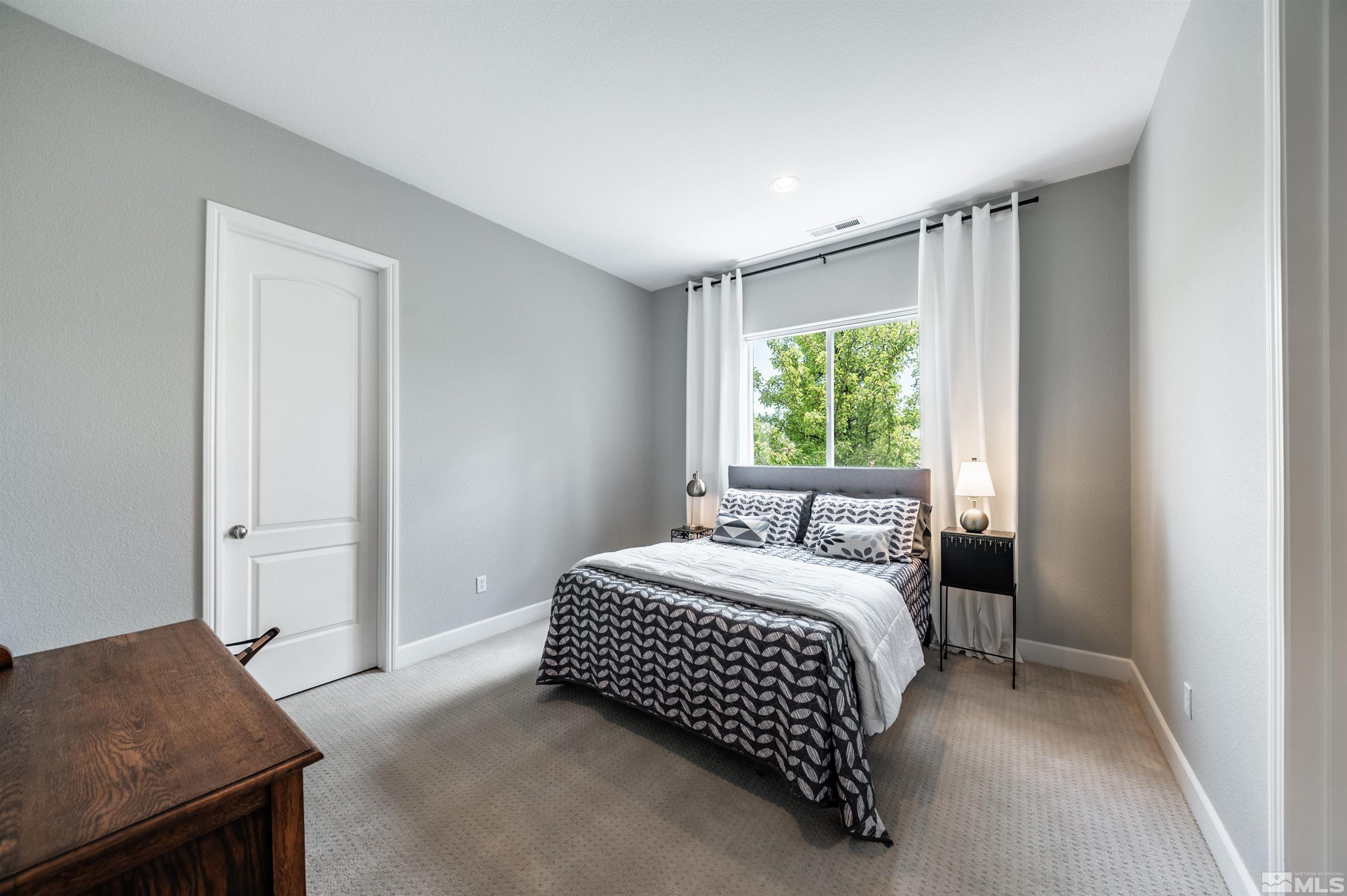 8580 Timaru Trail Reno, NV 89523 - Photo 32 of 40 a bedroom with a bed and a window