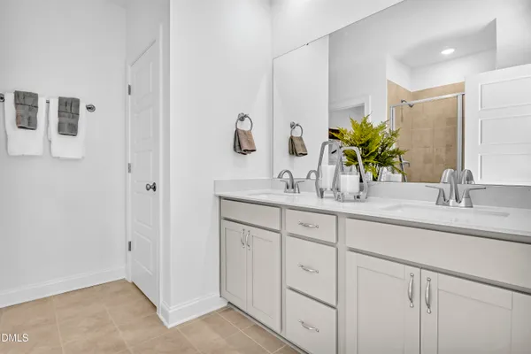 a bathroom with a double vanity sink and a mirror