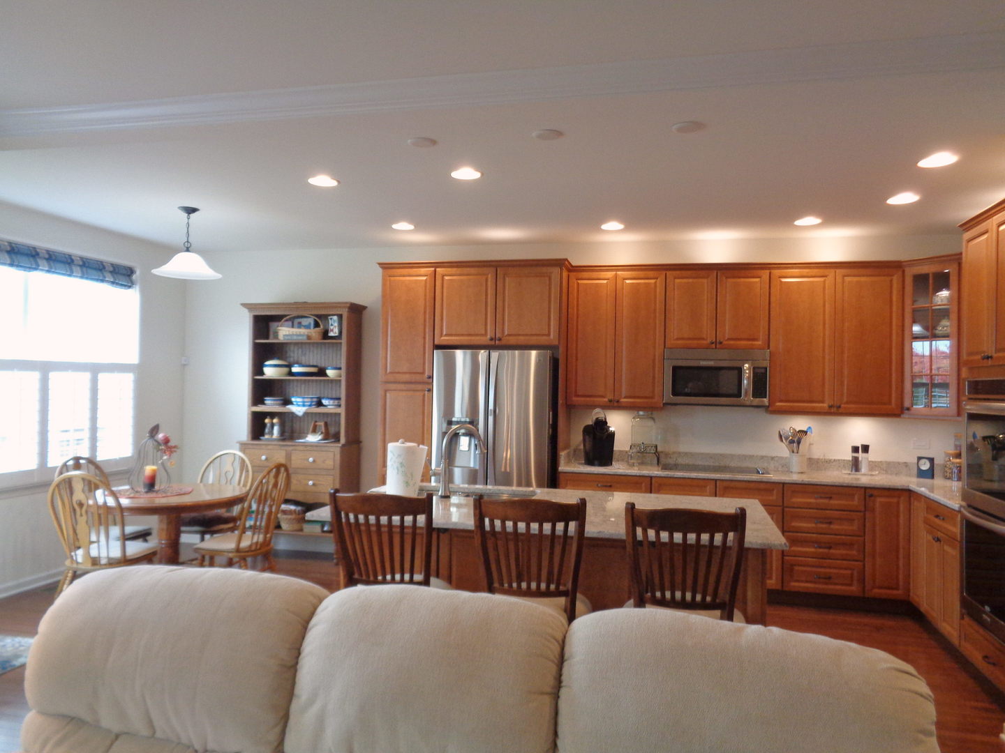 1157 Falcon Ridge Drive Elgin, IL 60124 - Photo 6 of 14 a kitchen with stainless steel appliances kitchen island granite countertop a dining table chairs and a refrigerator
