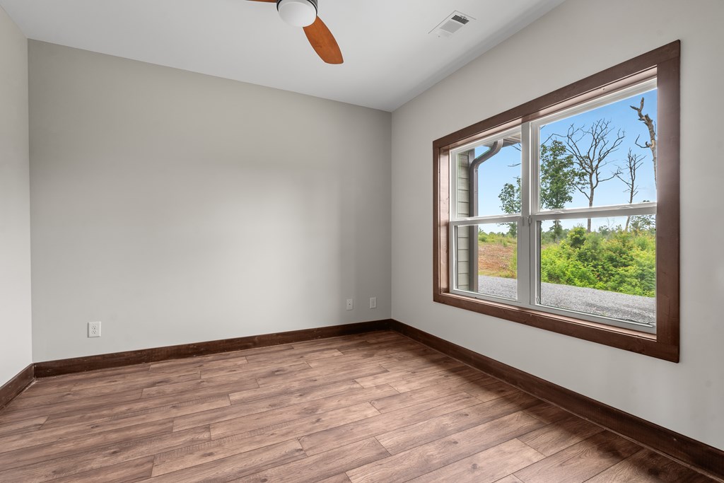 39 Mountaintown Overlook Ellijay, GA 30540 - Photo 13 of 51 a view of an empty room with wooden floor and a window