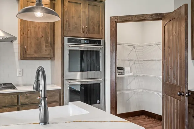 a kitchen with a refrigerator and a sink