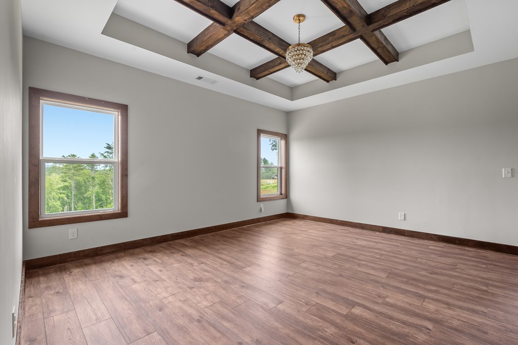 39 Mountaintown Overlook Ellijay, GA 30540 - Photo 25 of 51 an empty room with wooden floor chandelier fan and windows