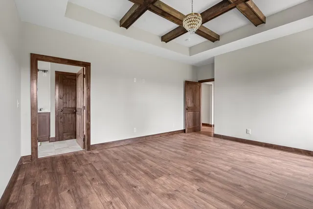 a view of an empty room with window and a ceiling fan