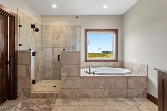 a bathroom with a bathtub a sink and a shower