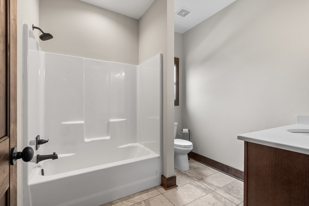 39 Mountaintown Overlook Ellijay, GA 30540 - Photo 29 of 51 a bathroom with a granite countertop bathtub shower and toilet