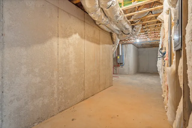 an empty room with wooden floor ceiling fan and windows