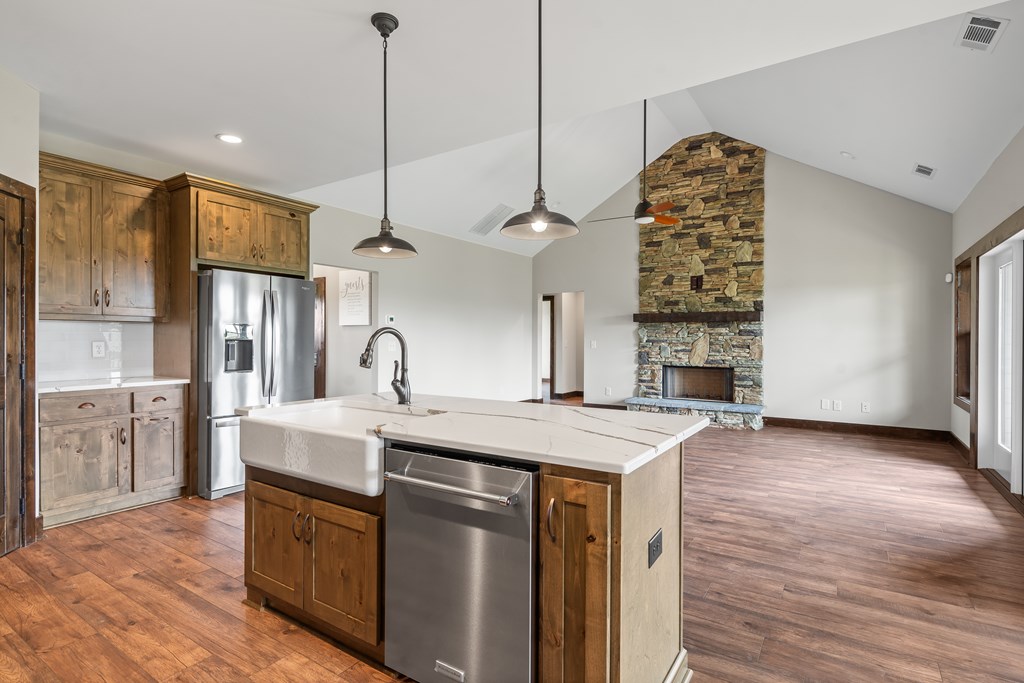 39 Mountaintown Overlook Ellijay, GA 30540 - Photo 4 of 51 a open kitchen with stainless steel appliances granite countertop a sink refrigerator and cabinets