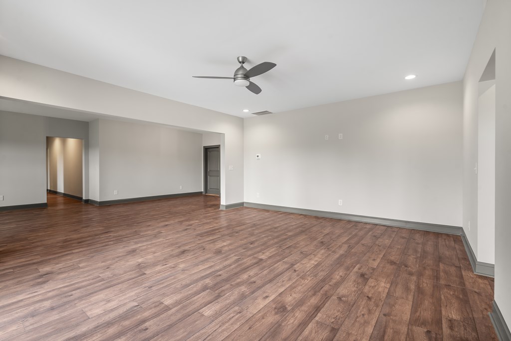 39 Mountaintown Overlook Ellijay, GA 30540 - Photo 41 of 51 an empty room with wooden floor ceiling fan and windows