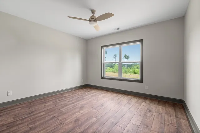wooden floor in an empty room with a window