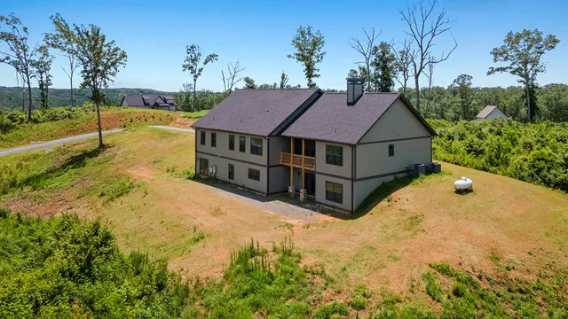 a view of a house with backyard and tree