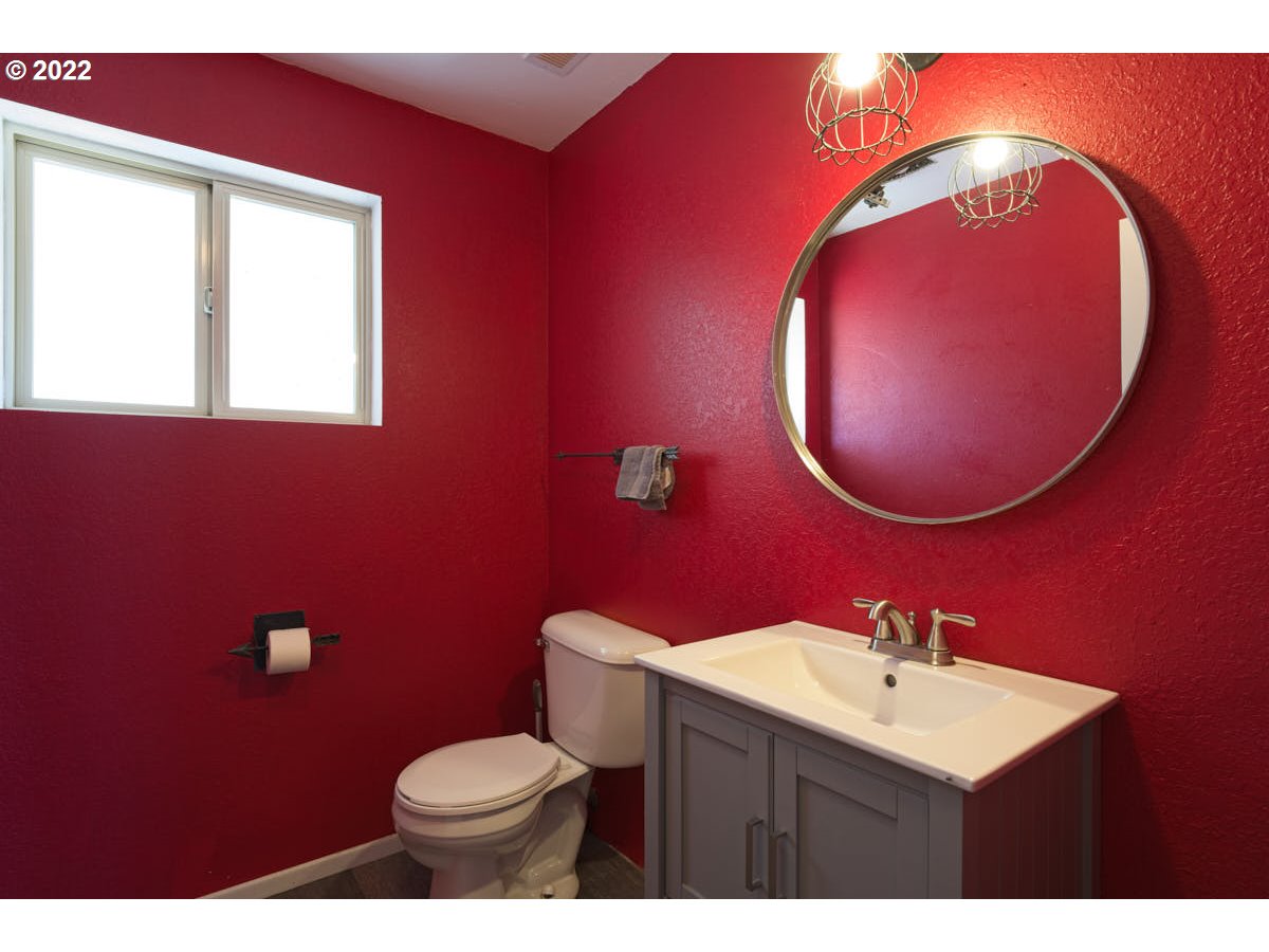 62333 Tucker Down Road Joseph, OR 97846 - Photo 13 of 32 a bathroom with a toilet a sink and mirror