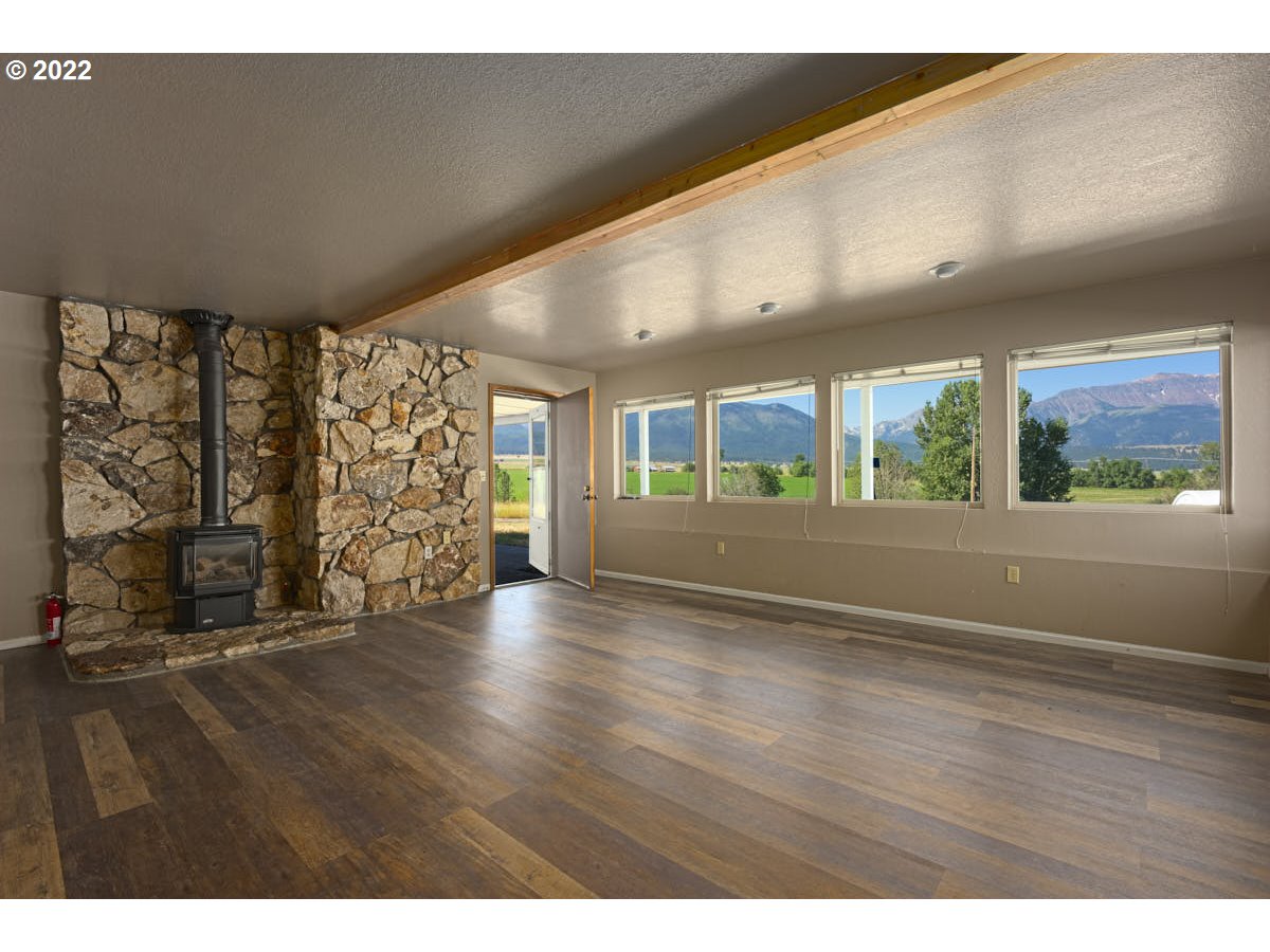 62333 Tucker Down Road Joseph, OR 97846 - Photo 14 of 32 a view of an empty room with wooden floor and a window