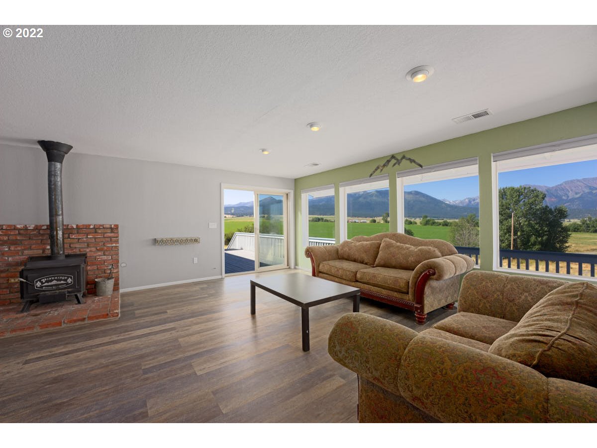 62333 Tucker Down Road Joseph, OR 97846 - Photo 4 of 32 a living room with furniture and a floor to ceiling window