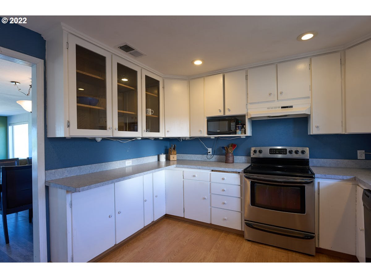 62333 Tucker Down Road Joseph, OR 97846 - Photo 7 of 32 a kitchen with stainless steel appliances granite countertop a stove and cabinets