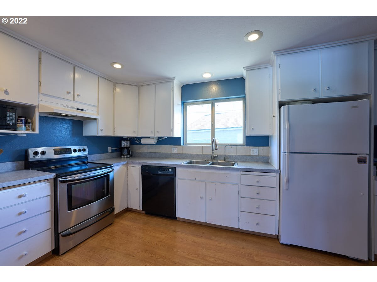 62333 Tucker Down Road Joseph, OR 97846 - Photo 8 of 32 a kitchen with granite countertop a sink stainless steel appliances and cabinets