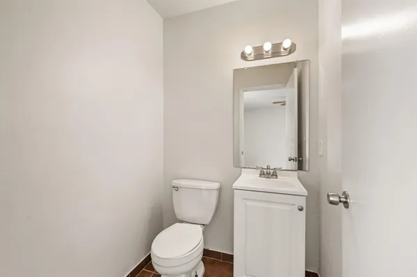 a white toilet sitting next to a bathroom sink