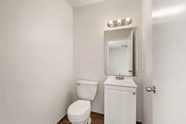 a white toilet sitting next to a bathroom sink