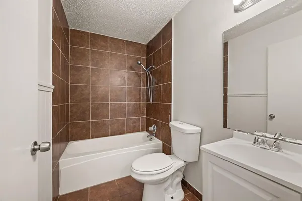 a bathroom with a sink a toilet and a bathtub