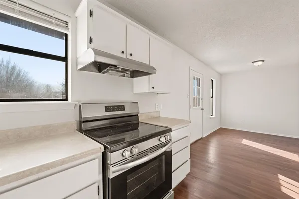 a kitchen with a stove and a microwave