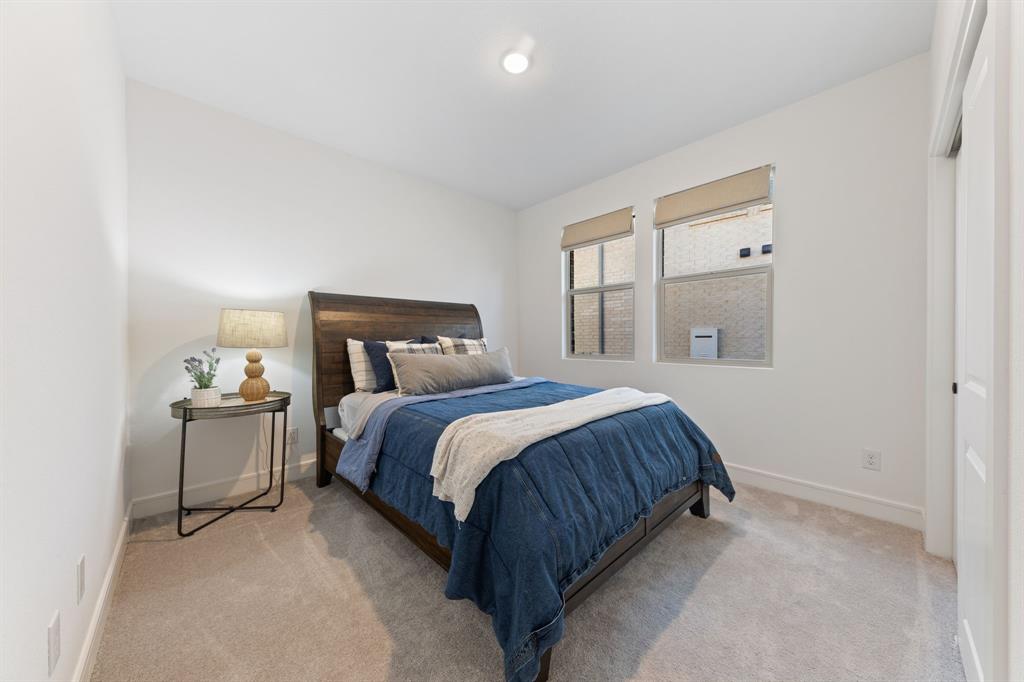 1340 Cartona Road Fate, TX 75087 - Photo 21 of 32 a bedroom with a bed and window