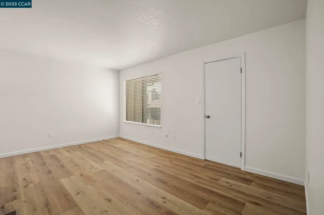 a view of kitchen with wooden floor and window