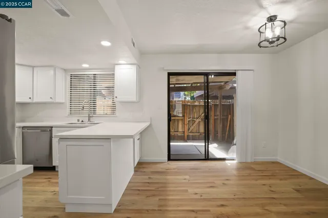 a kitchen with stainless steel appliances granite countertop a stove and a sink