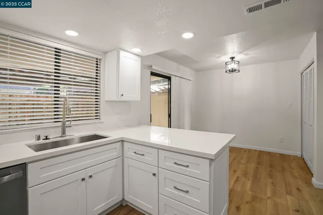 a kitchen with stainless steel appliances a refrigerator and a stove top oven