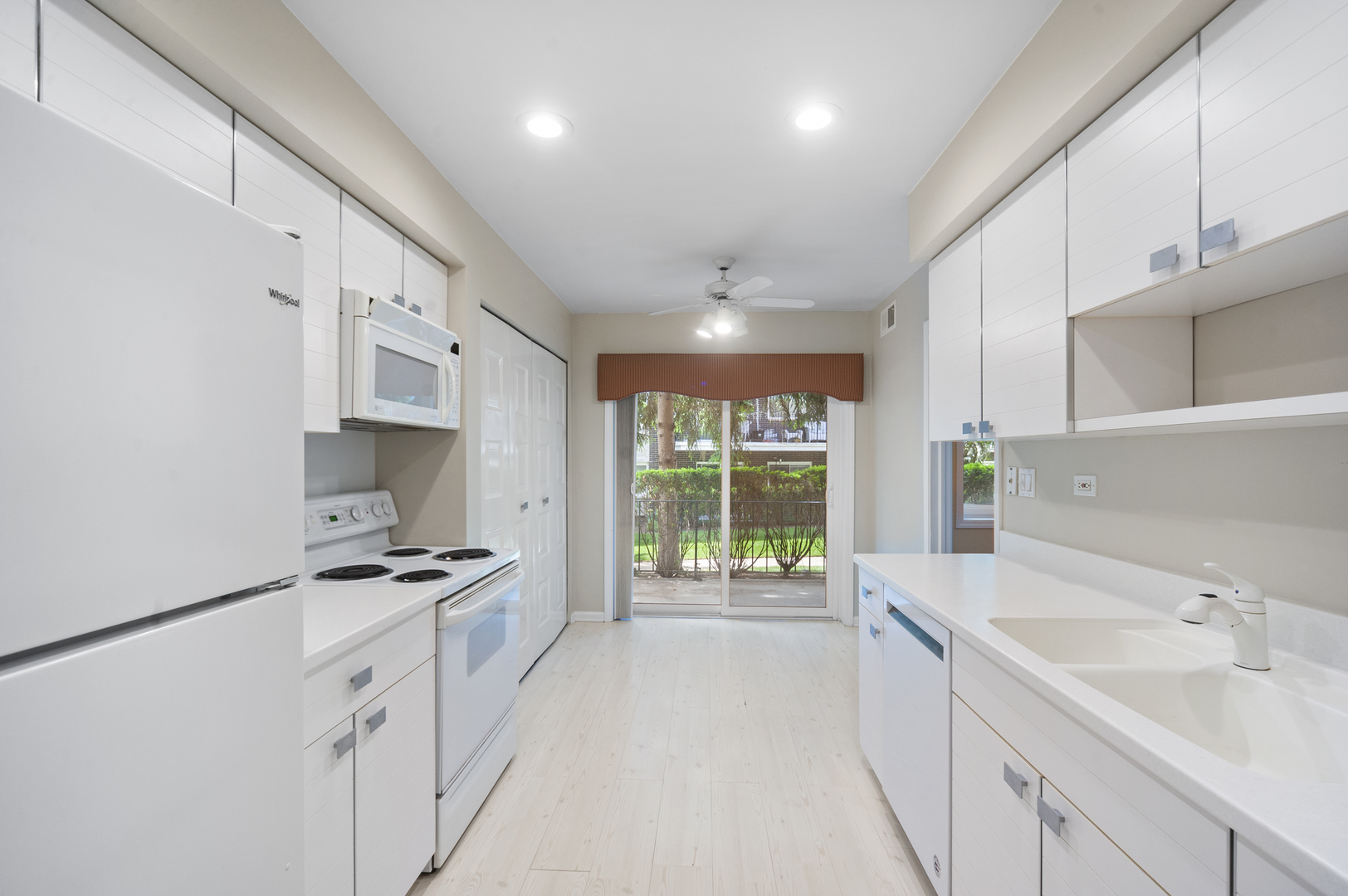 4949 Golf Road, Unit 101 Skokie, IL 60077 - Photo 8 of 22 a kitchen with granite countertop a sink stove and cabinets