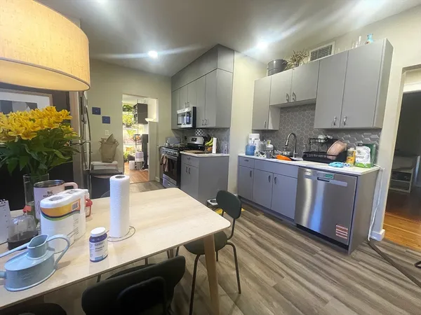 a kitchen with granite countertop a sink cabinets and appliances