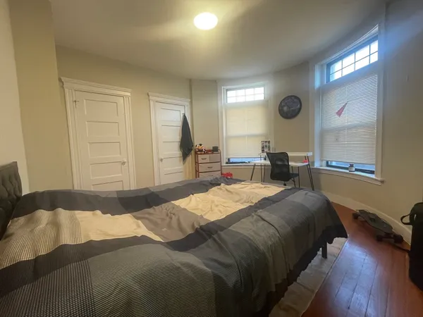 a bedroom with a bed window and a dresser