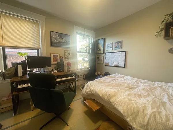 a bed sitting in a bedroom next to a window